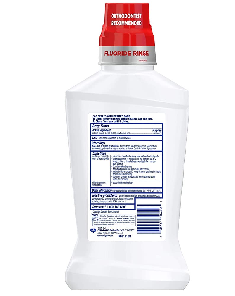 Colgate Phos-Flur Mint rinse being poured from the bottle.