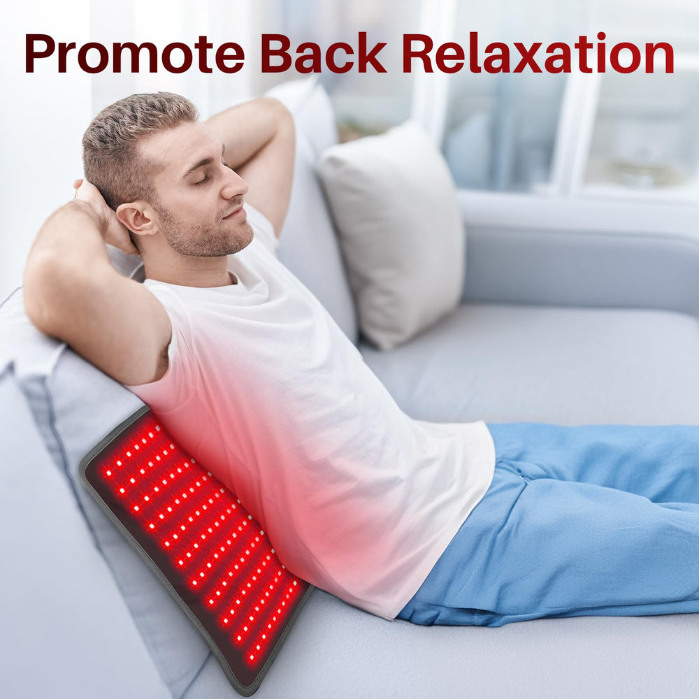 Comfytemp red light therapy pad resting on the shoulder to ease tension while working.