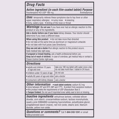 Person taking Curist tablet for daily allergy relief.