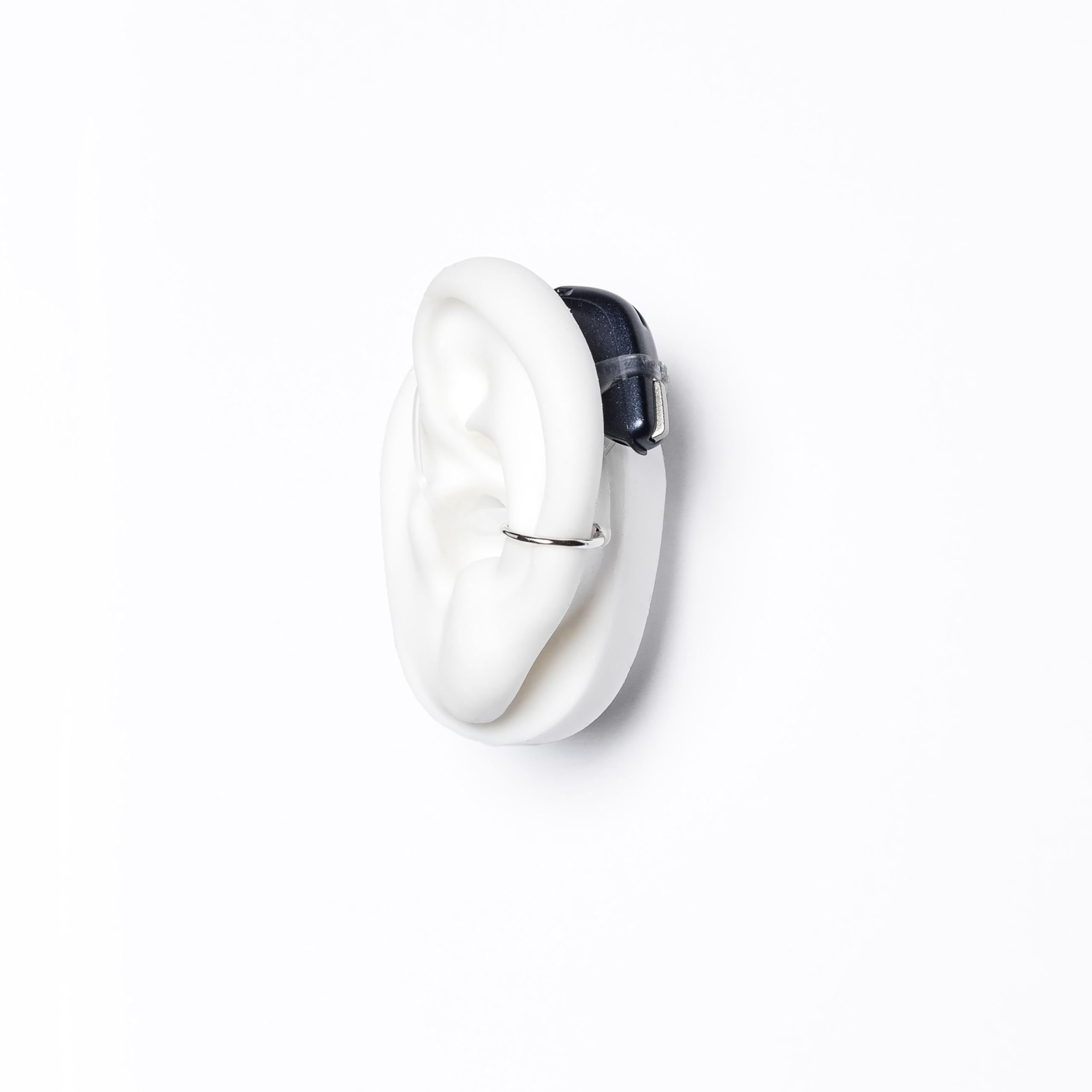Deafmetal silicone holster on the ear provides universal attachment for behind-the-ear devices.