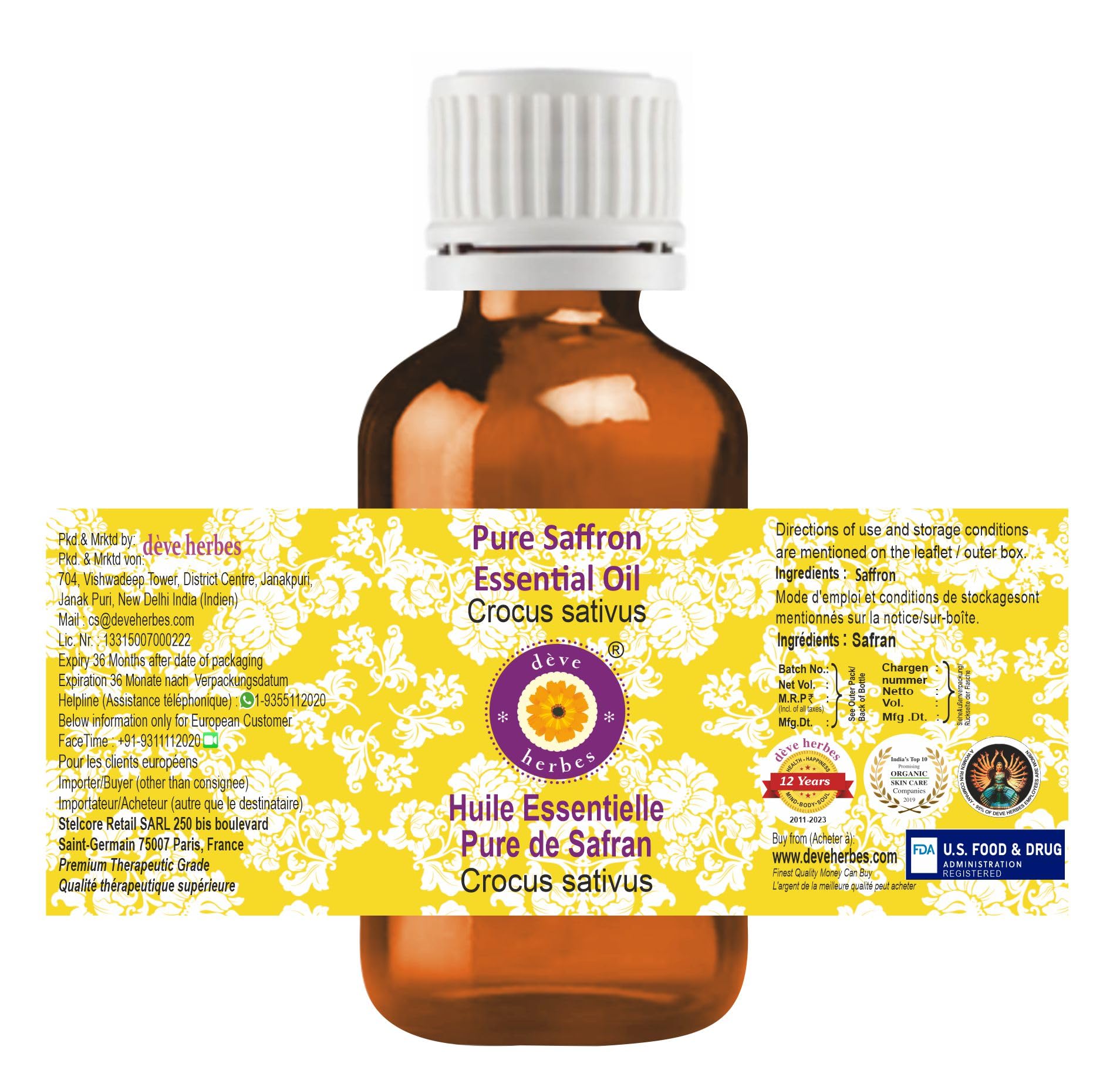 closeup of saffron essential oil cap showing brand and purity on amber bottle.
