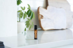 doTERRA Vetiver Touch roll-on application on skin for calming routine.
