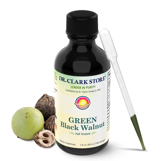 Dr. Clark Store green-black walnut hull tincture bottle on desk for daily digestive balance.
