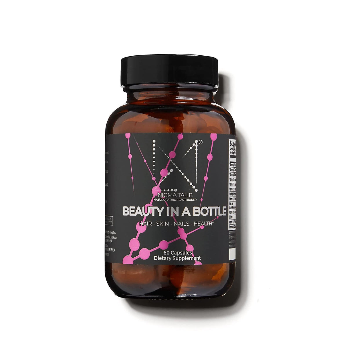 Dr. Nigma Beauty in a Bottle capsules close-up for hair and nails support.