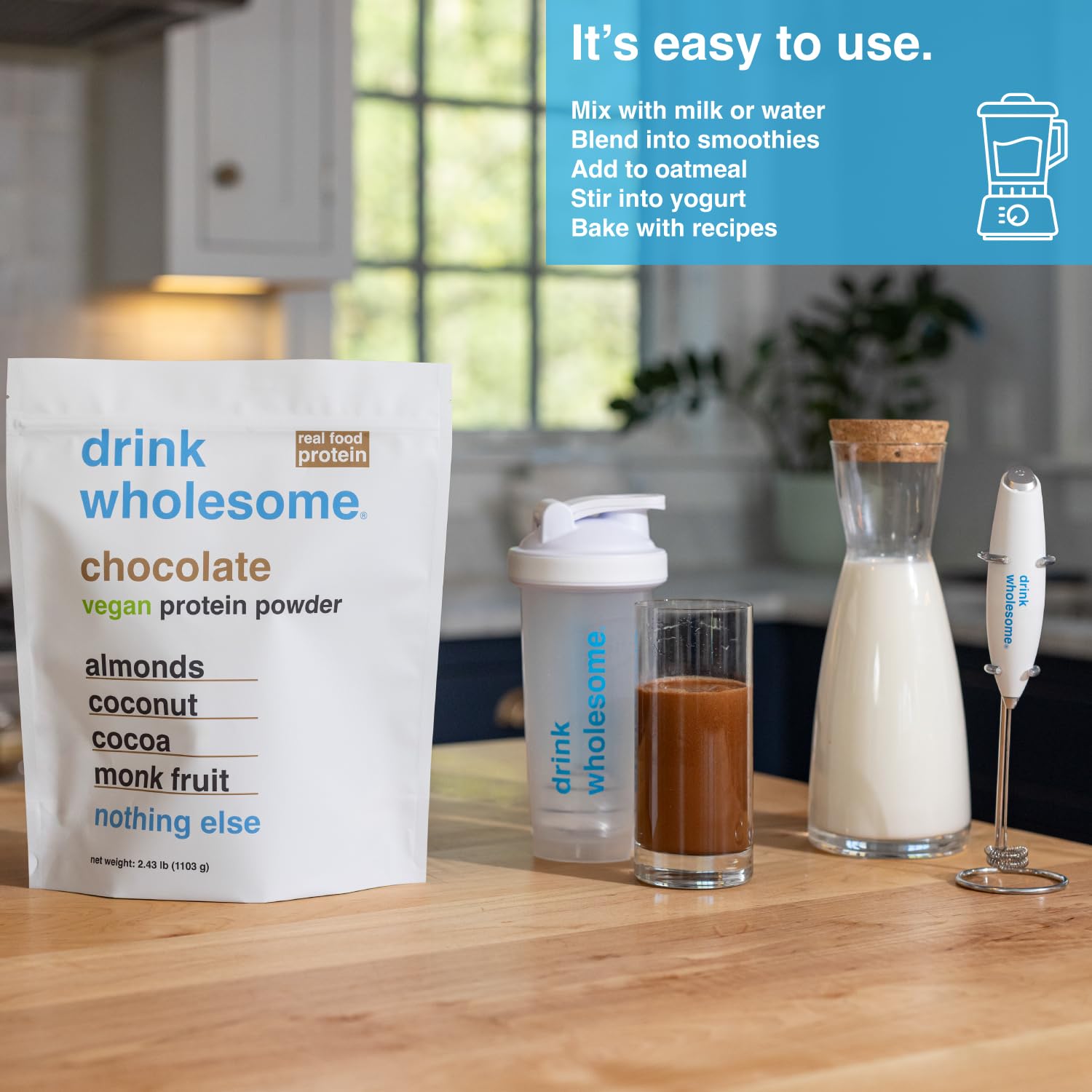 Serving glass with a smooth chocolate almond protein shake showing texture.