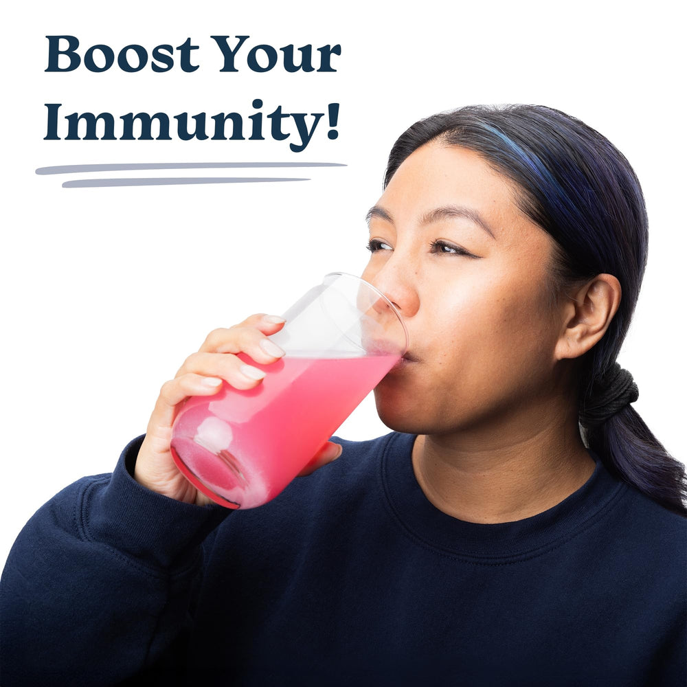 Drinklits strawberry tablets dissolving in water for a fizzy, flavorful vitamin drink.