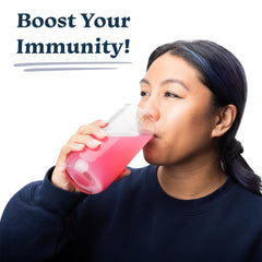 Drinklits strawberry tablets dissolving in water for a fizzy, flavorful vitamin drink.