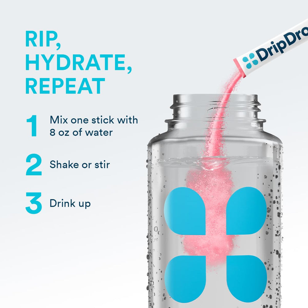 DripDrop sugar-free watermelon packet beside a glass of water ready to mix.