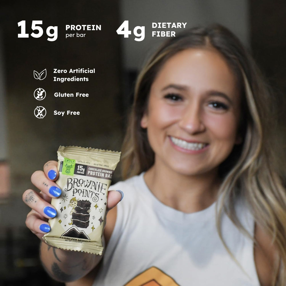 Earth Fed Muscle Brownie Points bar bite, showcasing chewy chocolate texture.