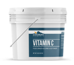 Earthborn Elements Vitamin C powder poured into a jar highlights a pure, additive-free formula.