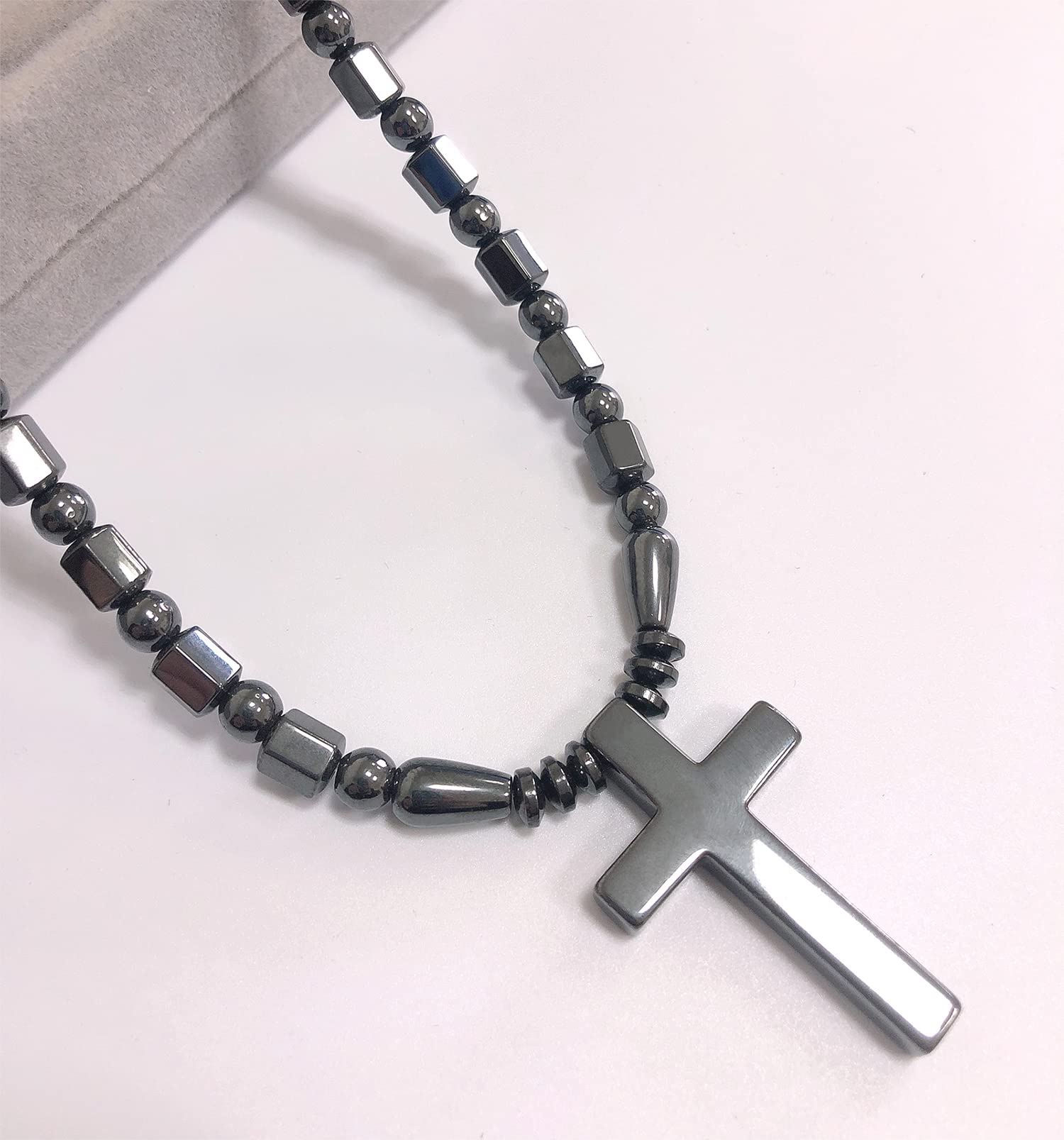Ecooon cross pendant magnetic closure shown securing the necklace during activity.