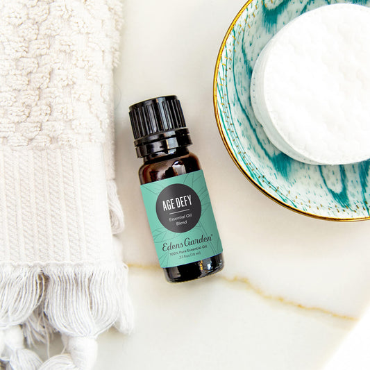 Edens Garden Age Defy bottle label highlights frankincense and sandalwood notes for skin nourishment.