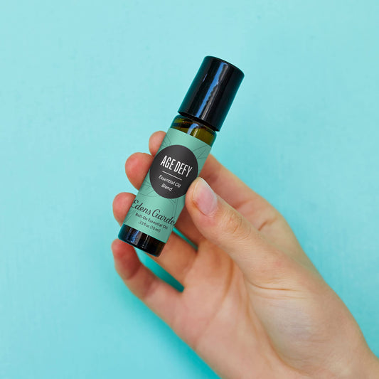 Edens Garden Age Defy roll-on applied on skin for quick facial nourishment and calming scent.