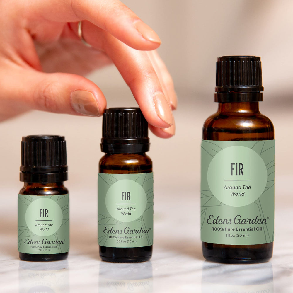 Edens Garden Fir Around The World bottle close-up showcasing pure oil for calming diffusion.