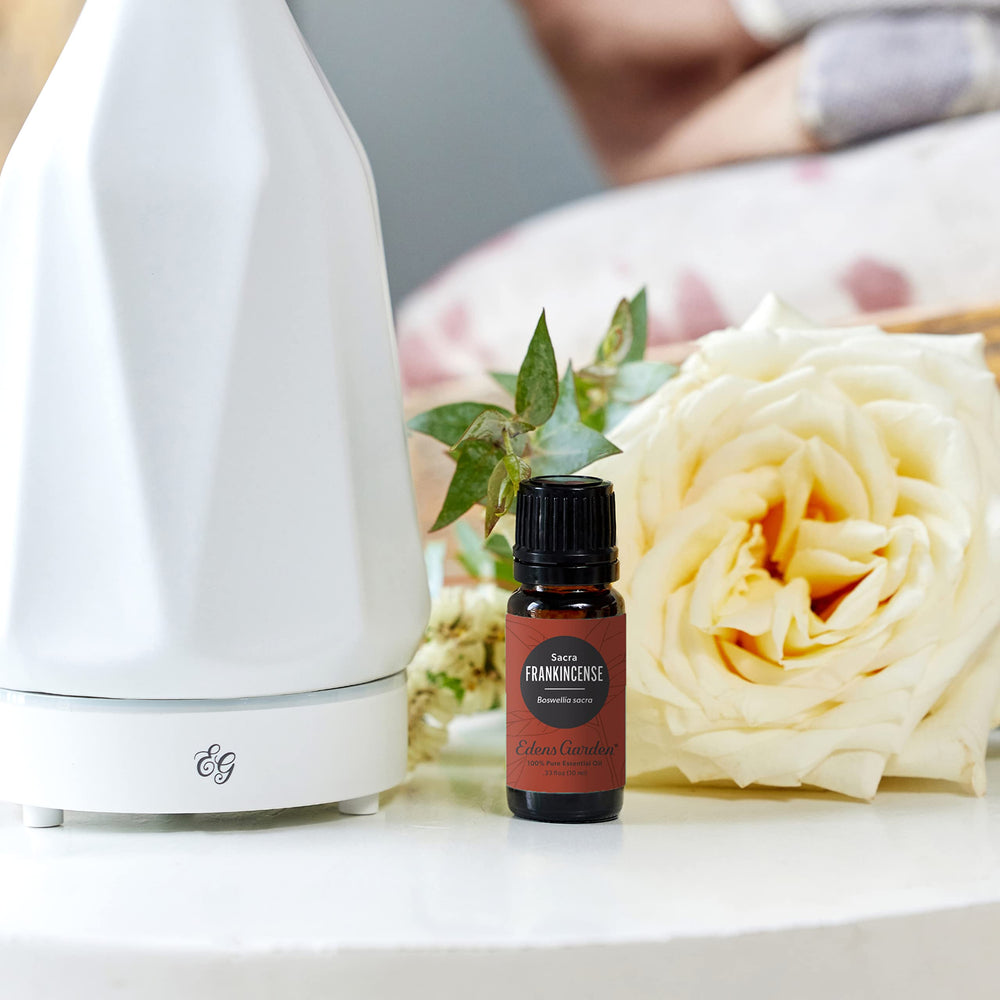 Edens Garden Frankincense Sacra bottle-pour showcases topical use with a carrier oil for skincare.