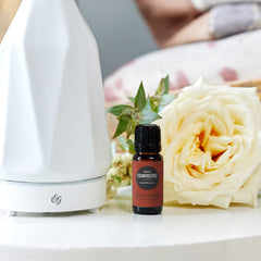 Edens Garden Frankincense Sacra bottle-pour showcases topical use with a carrier oil for skincare.