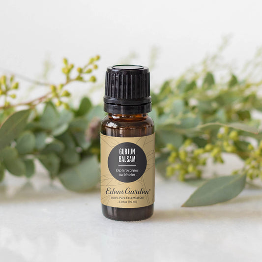 Edens Garden Gurjun Balsam essential oil in a diffuser for grounding ambiance.