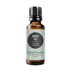 Edens Garden Nootka Tree oil bottle; rich woodsy aroma ideal for grounding spaces.