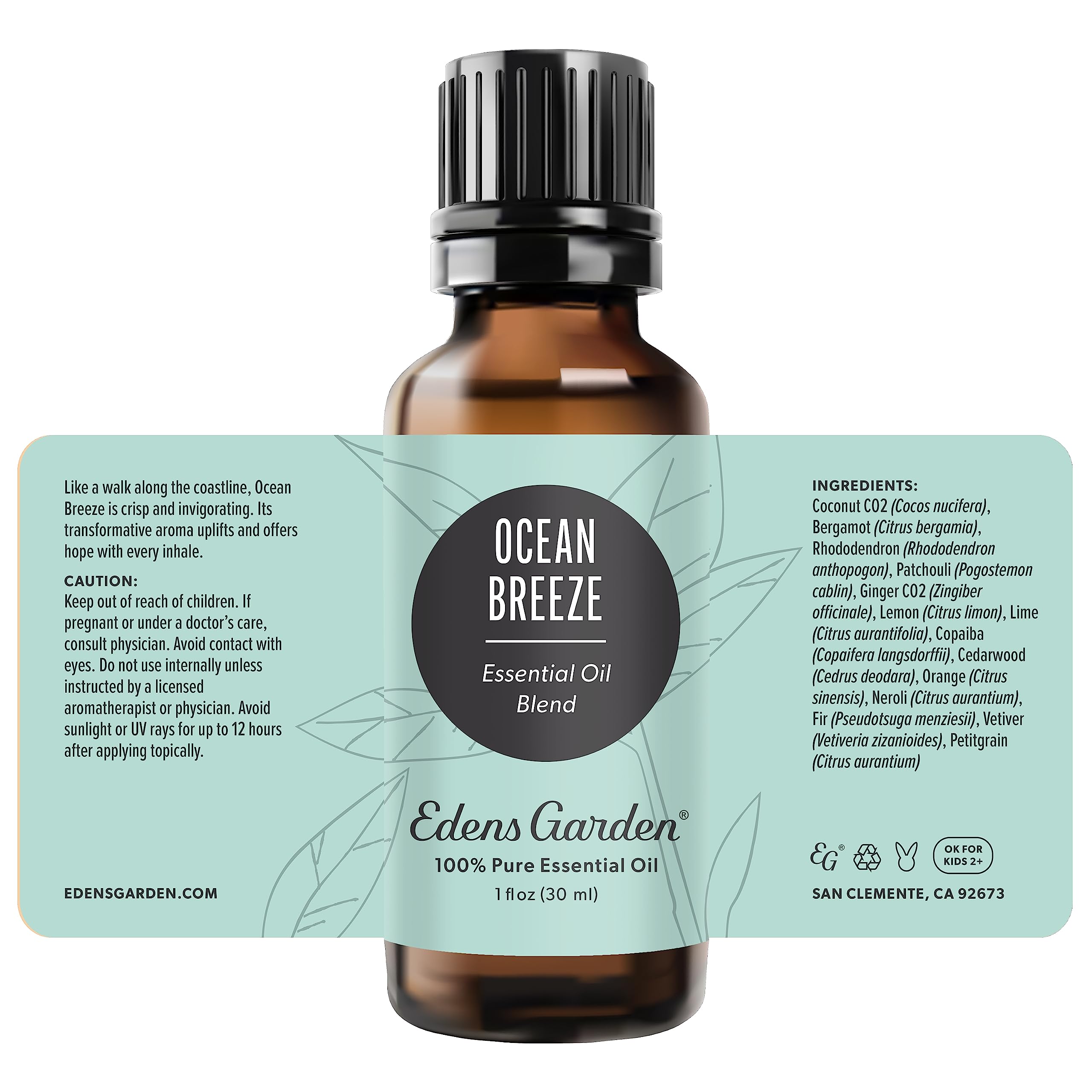 Edens Garden Ocean Breeze oil bottle beside candle for ambiance