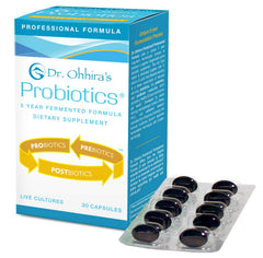 Essential Formulas Dr. Ohhira’s probiotic bottle on desk, highlighting five-year fermentation.