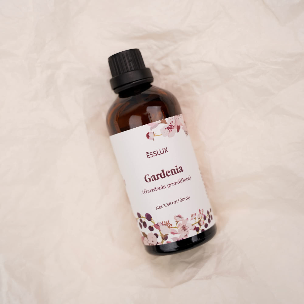 Amber glass bottle of Gardenia oil by ESSLUX with dropper