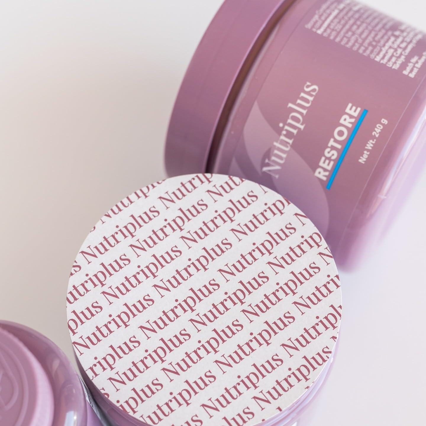 Farmasi Nutriplus Restore mixed in a glass of water for easy consumption.