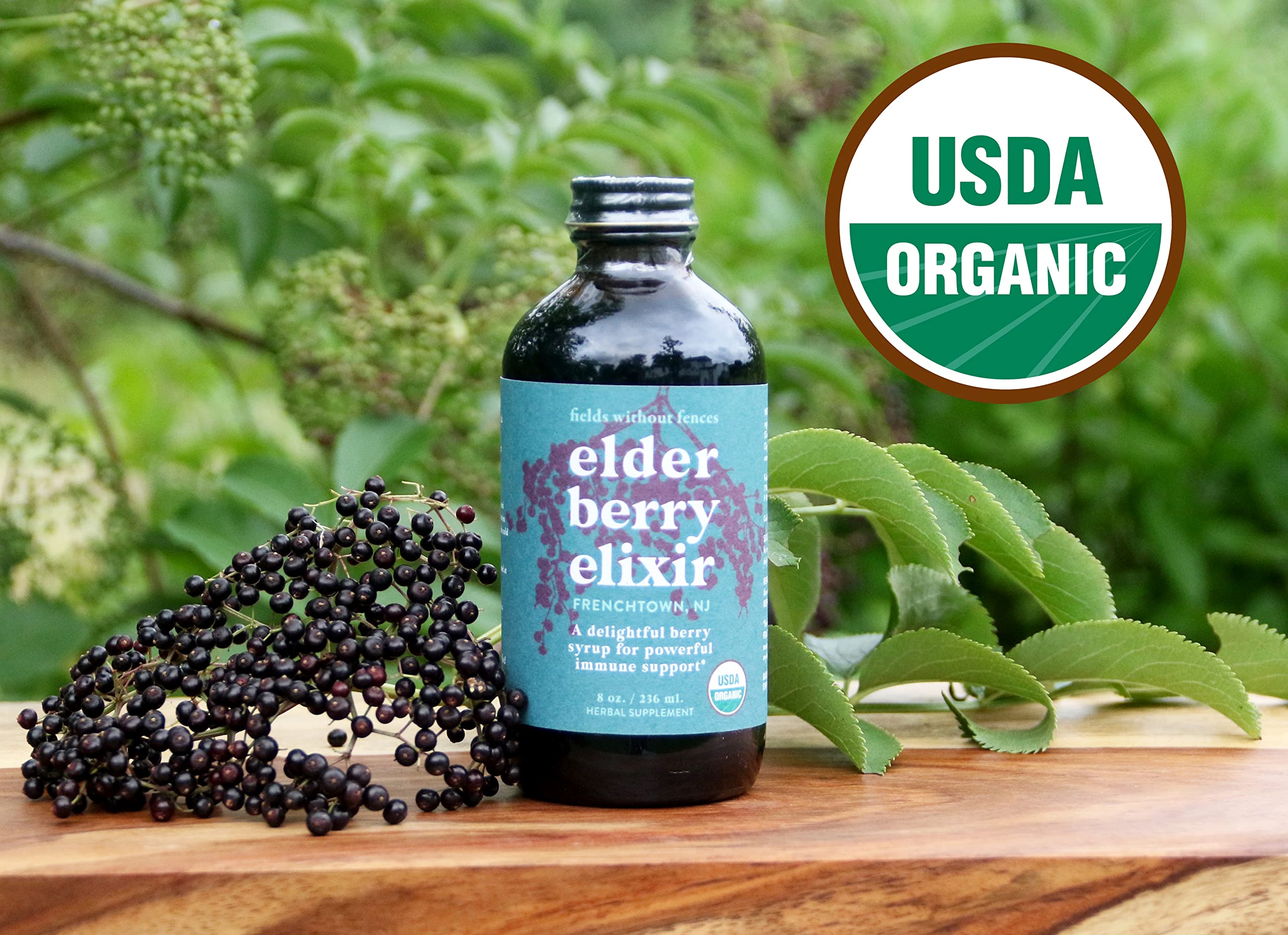 Fields Without Fences Elderberry Elixir bottle in a family kitchen, signaling kid-friendly daily use.