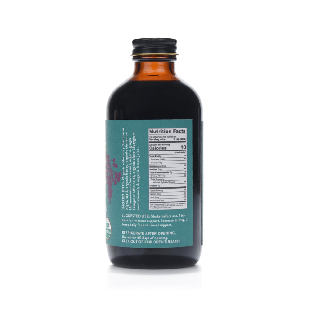 Fields Without Fences Elderberry Elixir ingredients close-up: organic elderberries, honey, cinnamon, ginger, clove.
