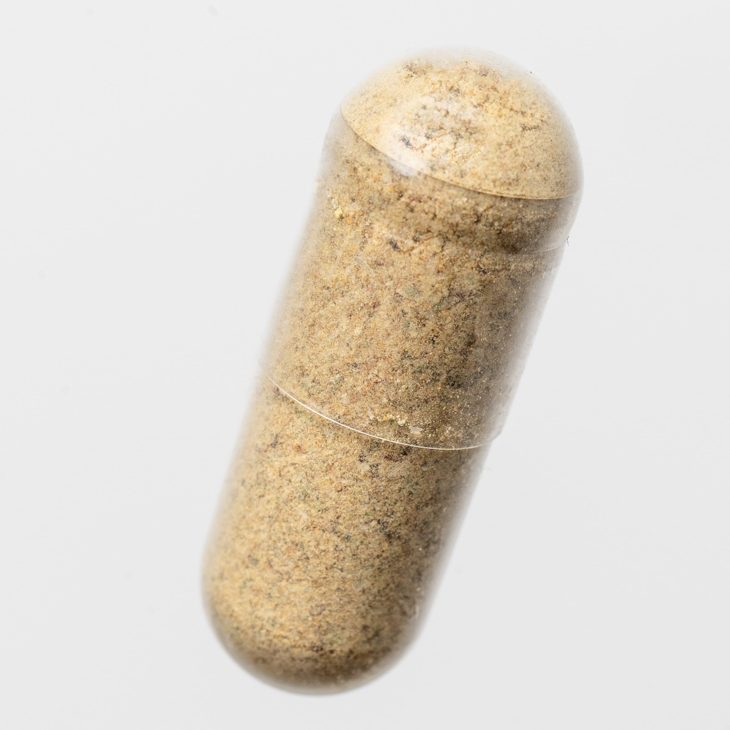 Food Over Drugs Colon Formula capsules next to a measuring cup for bedtime routine.