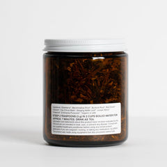 Food Over Drugs detox tea herbs close-up showing elderberry, burdock, and nettle.