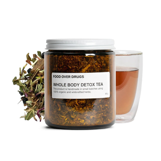 Food Over Drugs detox tea loose-leaf blend in a glass jar for daily wellness.