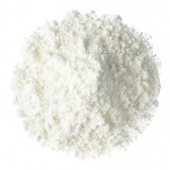 Food to Live Creatine Monohydrate Micronized Powder poured into a glass shows rapid dissolution.
