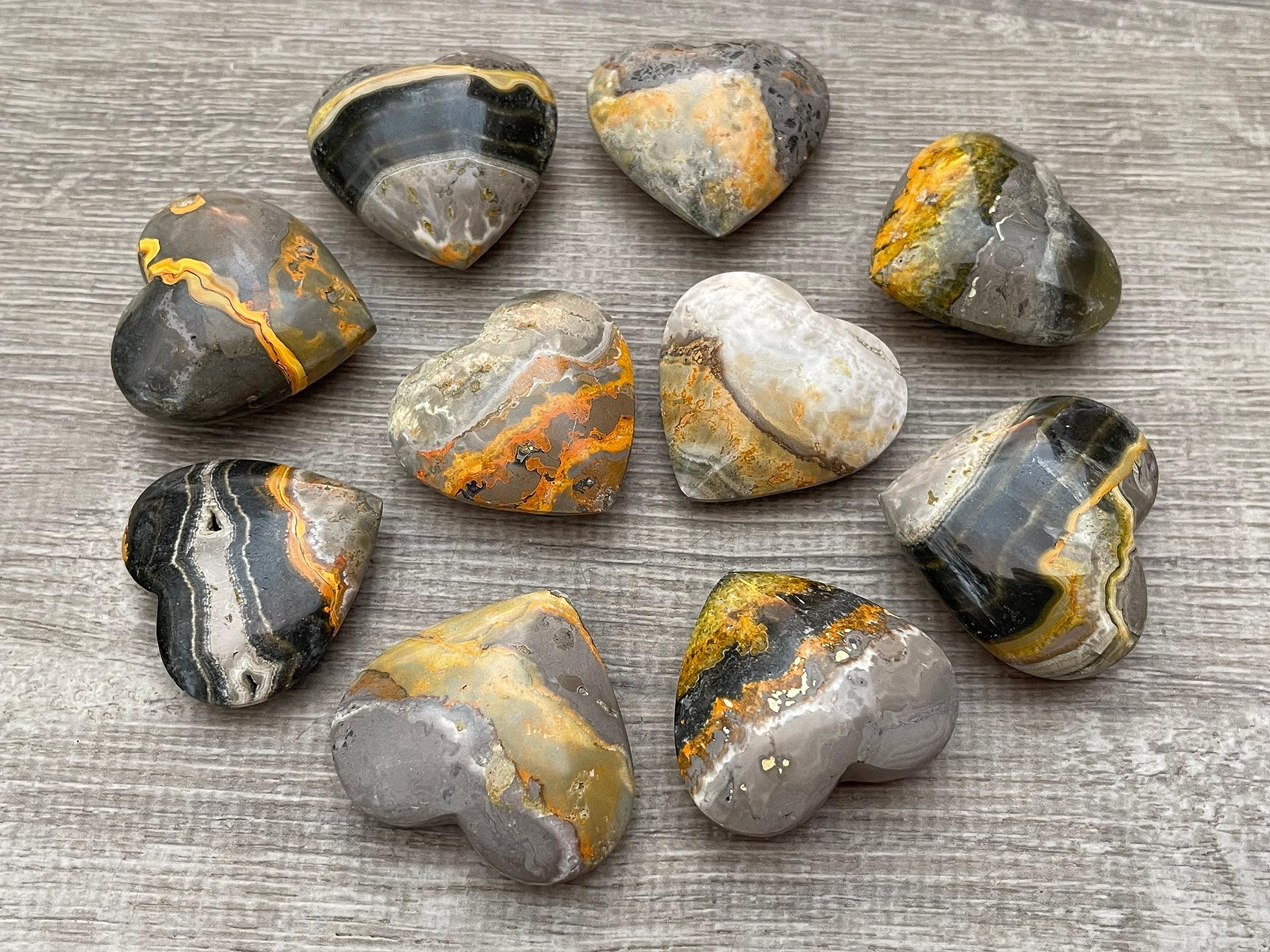 GAF Treasures Bumble Bee Jasper palm stone held in hand for grounding energy