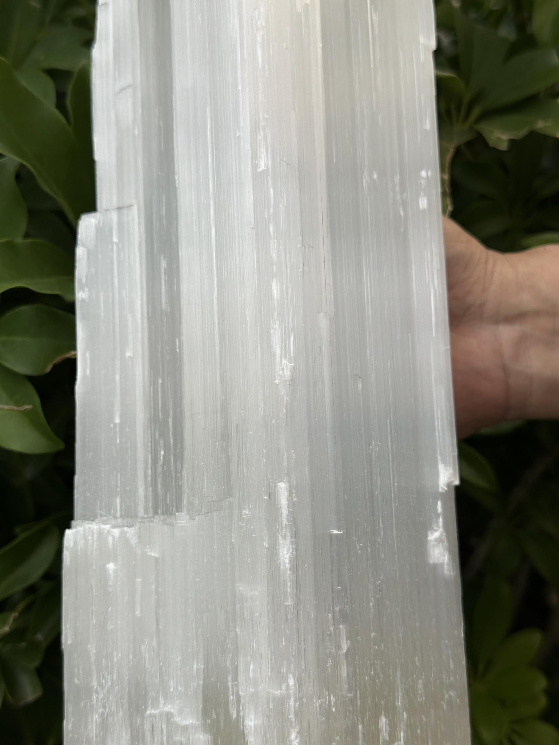 GAF TREASURES jumbo selenite log beside fireplace as centerpiece