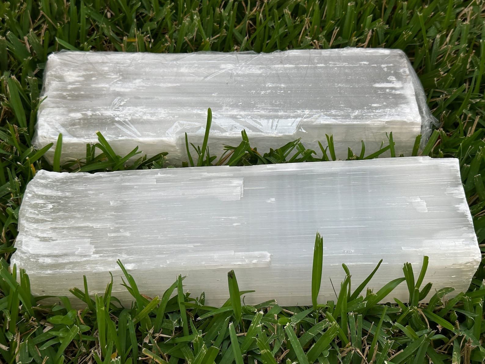 GAF TREASURES natural white selenite log closeup — milky glow and crystalline texture.