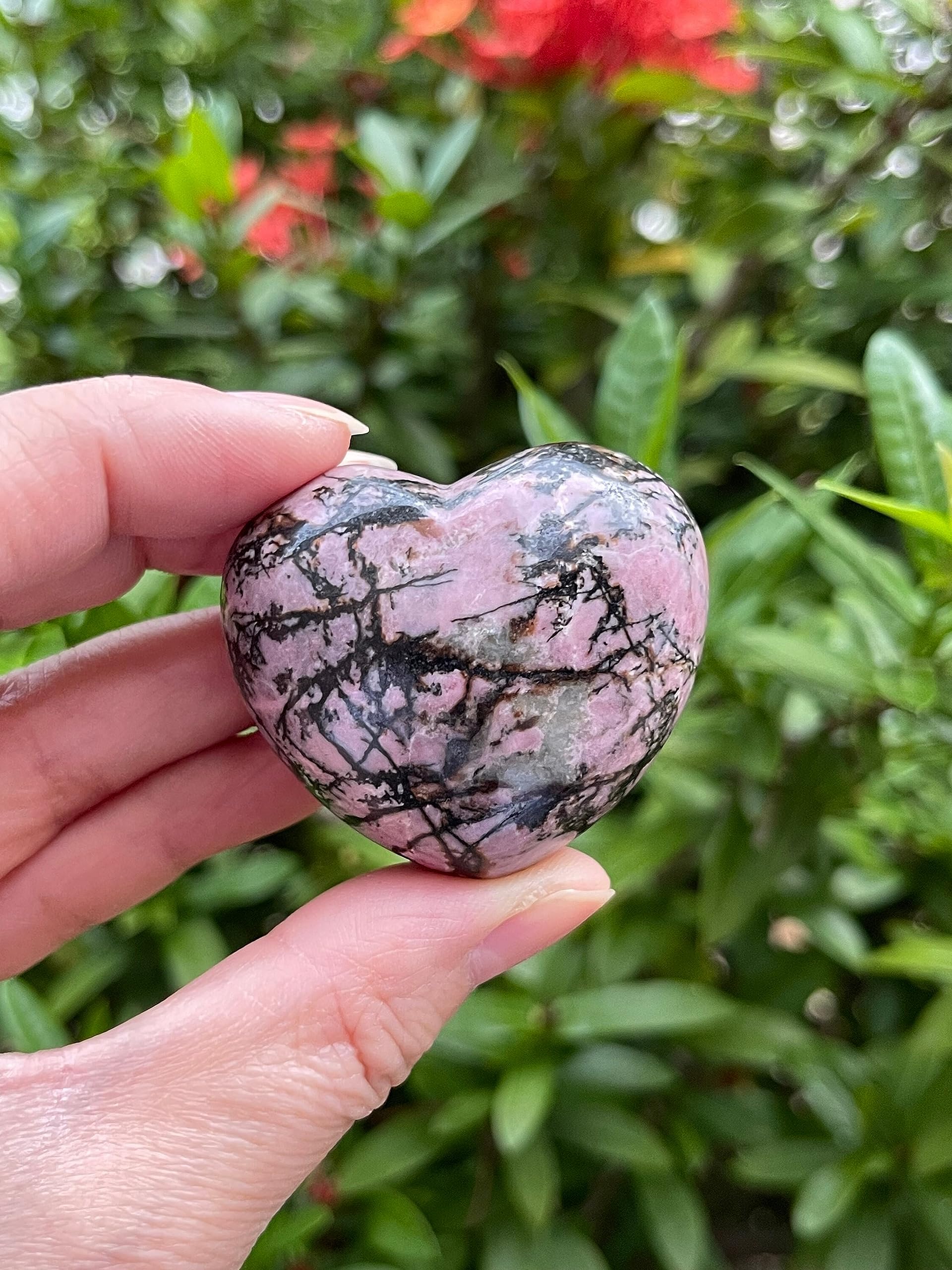 GAF Treasures Rhodonite healing crystal heart glowing with rosy pink shades