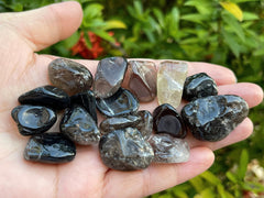 GAF Treasures smoky quartz polished rocks arranged for energy work.