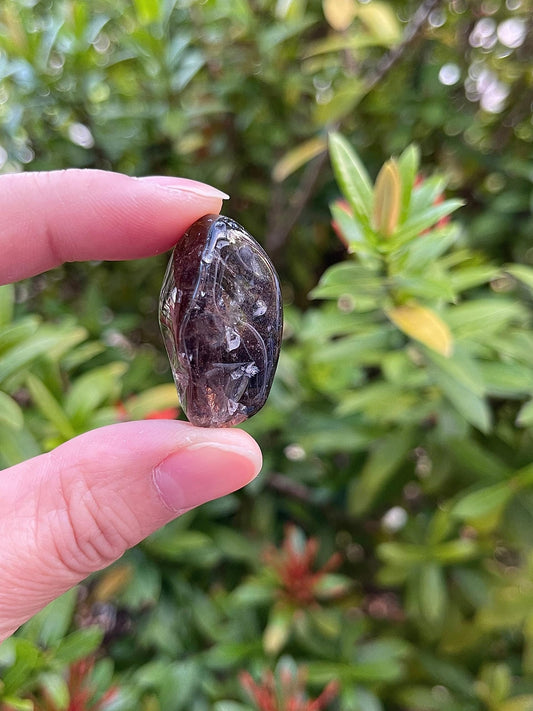 GAF Treasures smoky quartz tumbled stones in hand for portable grounding.