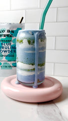 Pure water-extracted spirulina powder displayed beside jar on counter.