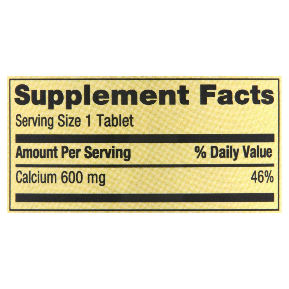 Generic Spring Valley Calcium 600mg bottle being poured into a glass.
