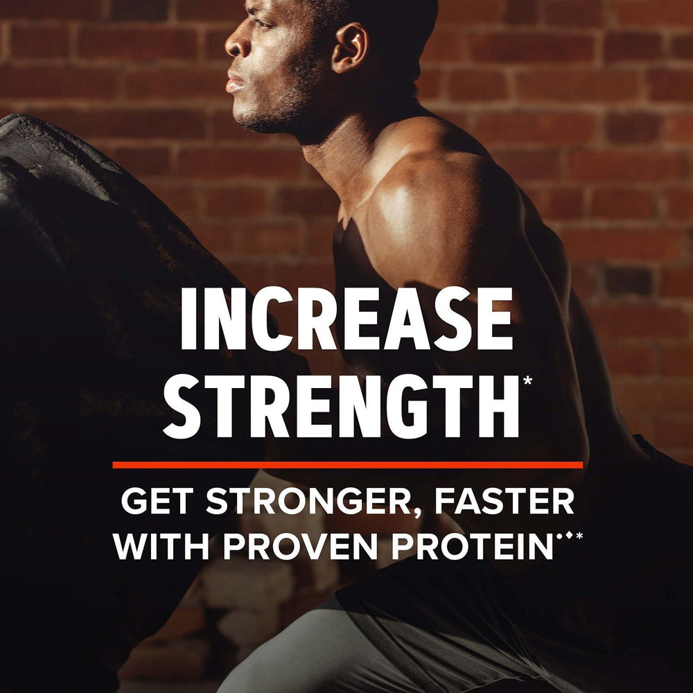 GNC AMP Wheybolic Alpha shake being poured for post‑workout recovery