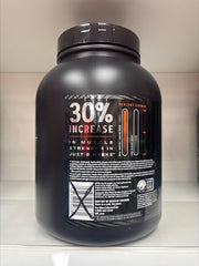 GNC AMP Wheybolic coconut caramel bag and packaging on desk