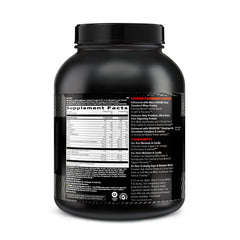 GNC AMP Wheybolic coconut caramel scoop beside bottle for easy mixing