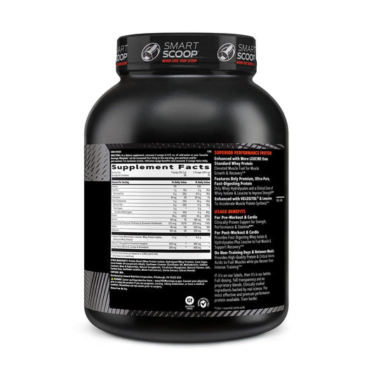 GNC AMP Wheybolic scoop beside the tub ready for post-workout shake.