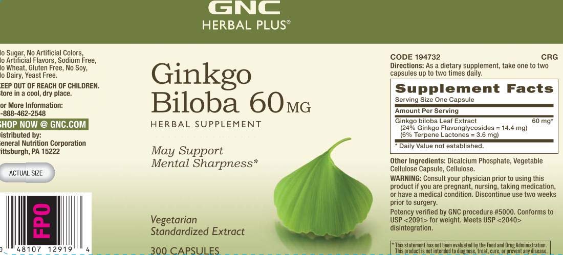 Person studying at a desk with GNC Herbal Plus Ginkgo Biloba for study focus.