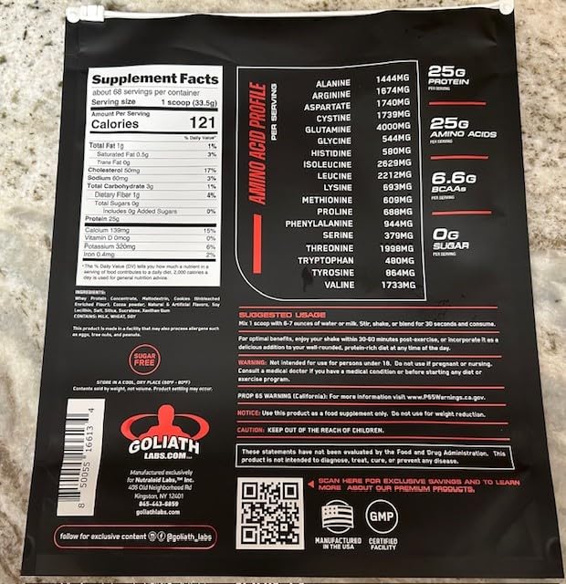 Goliath Labs whey powder scoop beside the tub for quick servings.