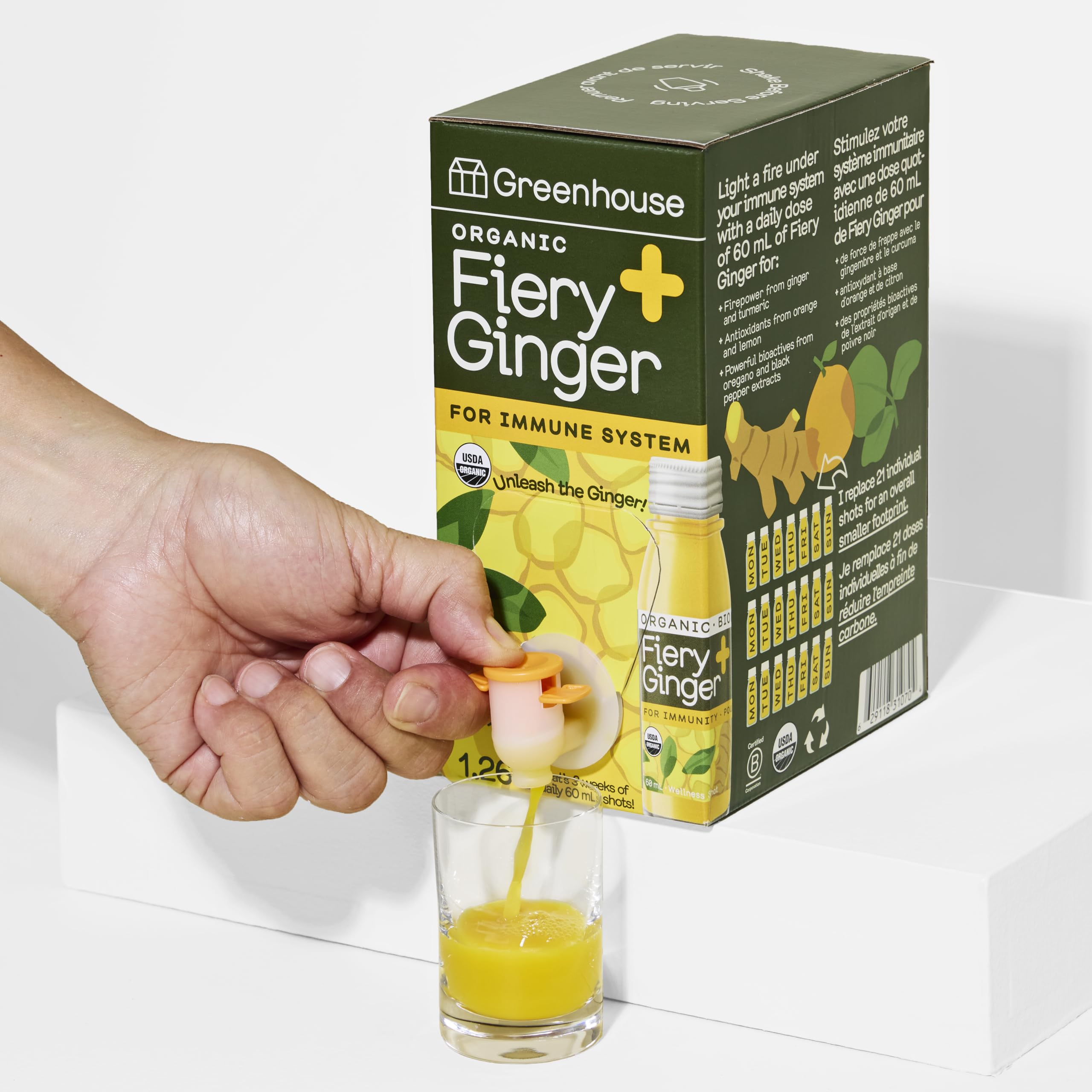 Greenhouse Juice Co Fiery Ginger Wellness Shot Box pour, bold spicy flavor for on-the-go use.