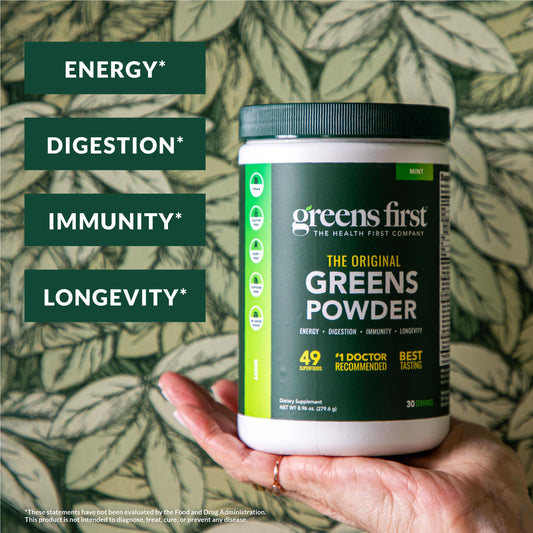 Greens First Berry flavor powder in glass ready for a smoothie.
