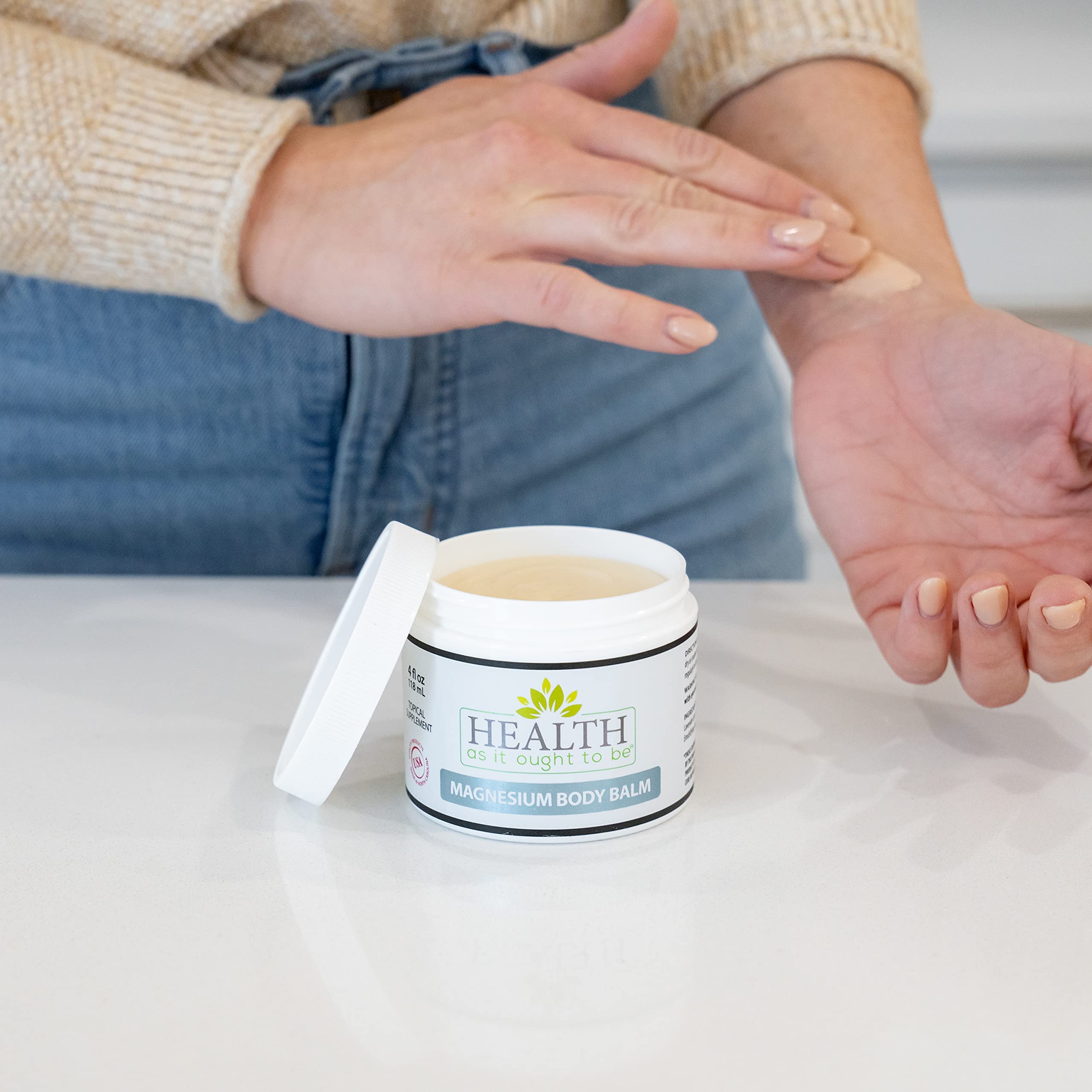 Health As It Ought To Be magnesium balm tub close-up showing creamy texture