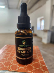 Healthergize Hemp Oil Premium dropper in use suggesting precise dosing.